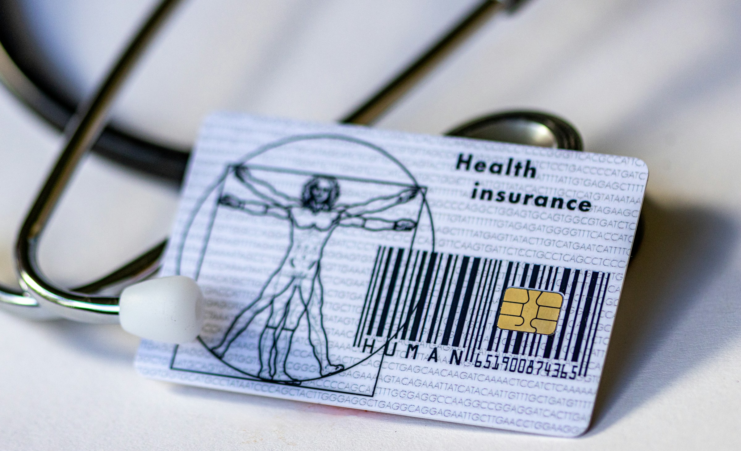 a health card and a stethoscope. Photo by Marek Studzinski on Unsplash